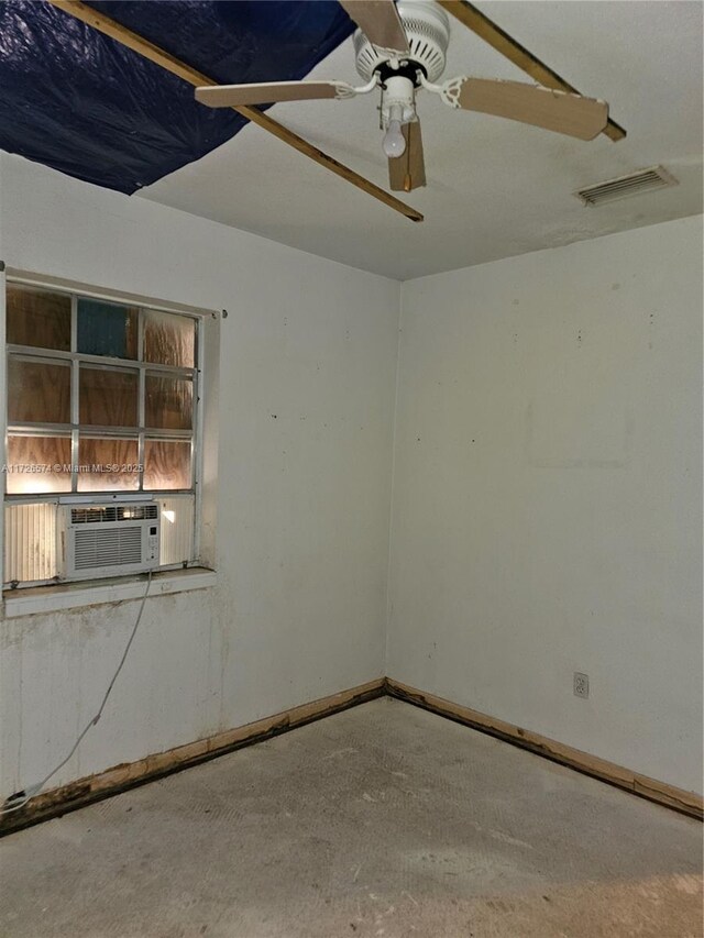 spare room with cooling unit, ceiling fan, and concrete floors