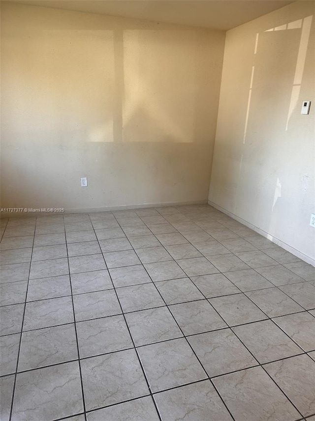 unfurnished room with light tile patterned floors