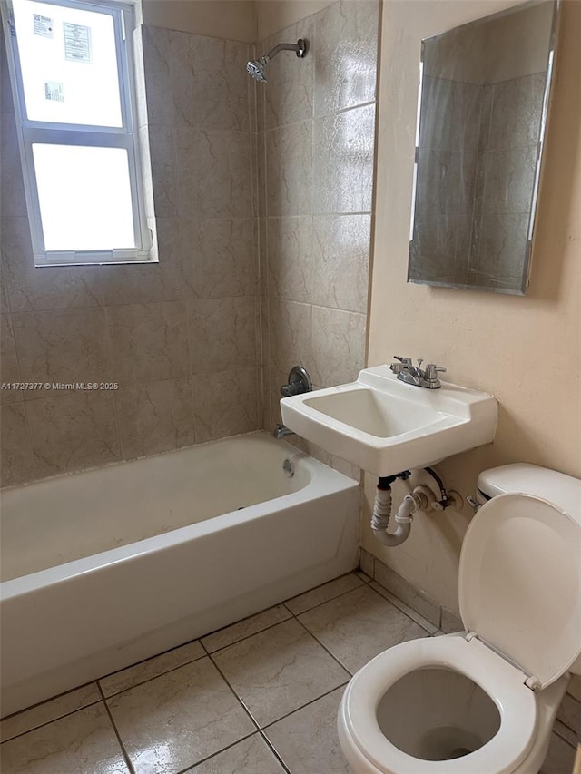 full bathroom featuring sink, tile patterned floors, toilet, and tiled shower / bath combo