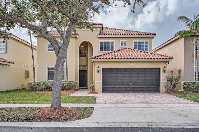 mediterranean / spanish house featuring a garage