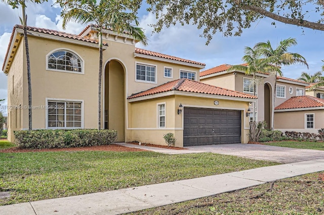 mediterranean / spanish-style house with a garage and a front yard