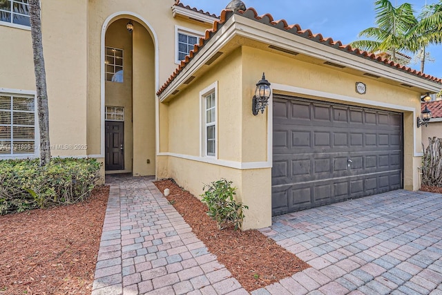 view of exterior entry featuring a garage