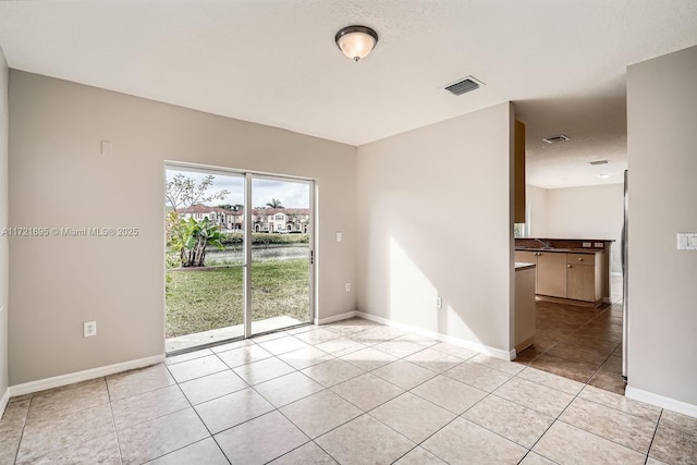 empty room with sink and light tile patterned flooring