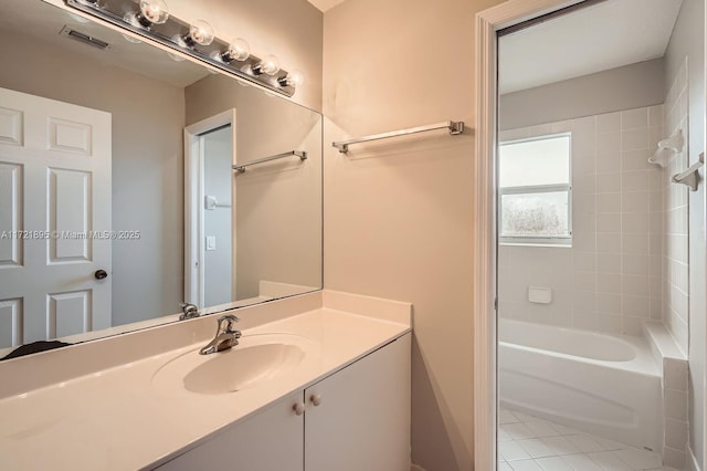 bathroom with  shower combination, tile patterned flooring, and vanity