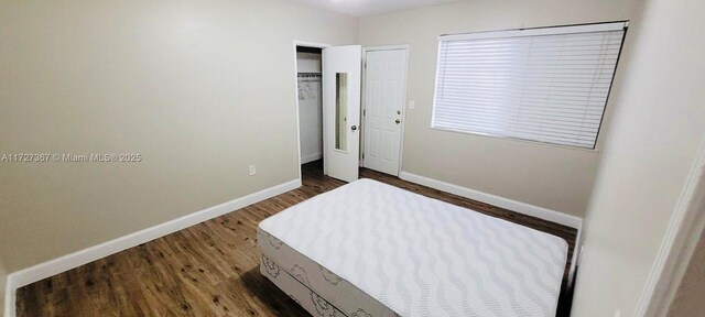 unfurnished bedroom with dark hardwood / wood-style floors