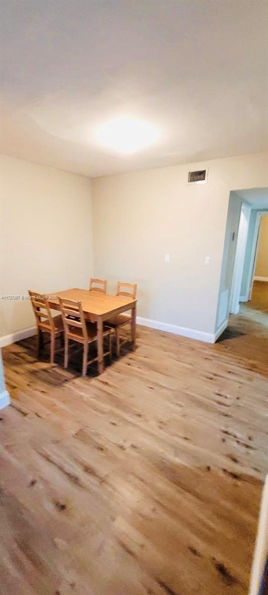 dining space featuring wood-type flooring