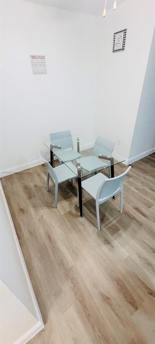 dining space with light wood-type flooring