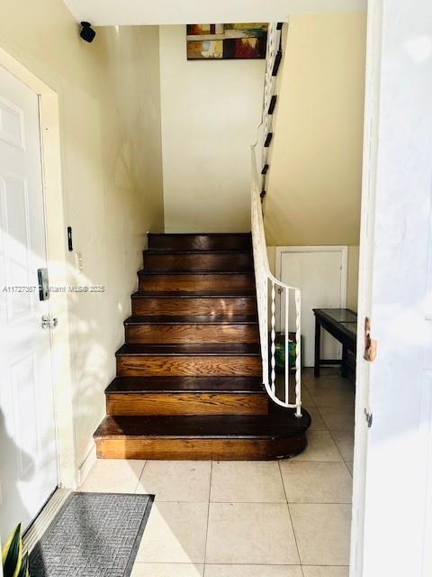 staircase with tile patterned floors