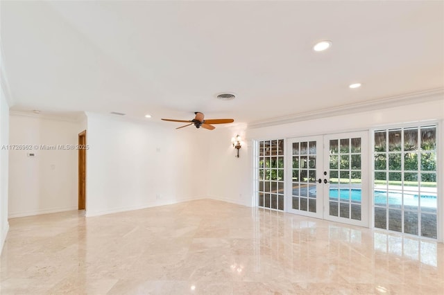 empty room featuring ceiling fan, ornamental molding, and french doors