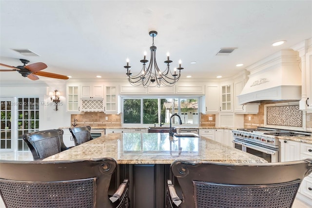 kitchen with double oven range, a kitchen breakfast bar, and a spacious island