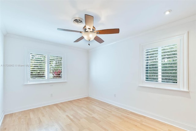 empty room with ceiling fan, ornamental molding, and light hardwood / wood-style floors