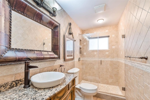 bathroom with toilet, tile walls, walk in shower, and vanity