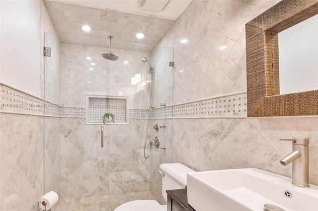 bathroom featuring an enclosed shower, tile walls, sink, and toilet