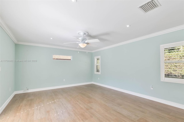 spare room with ceiling fan, crown molding, and light hardwood / wood-style floors