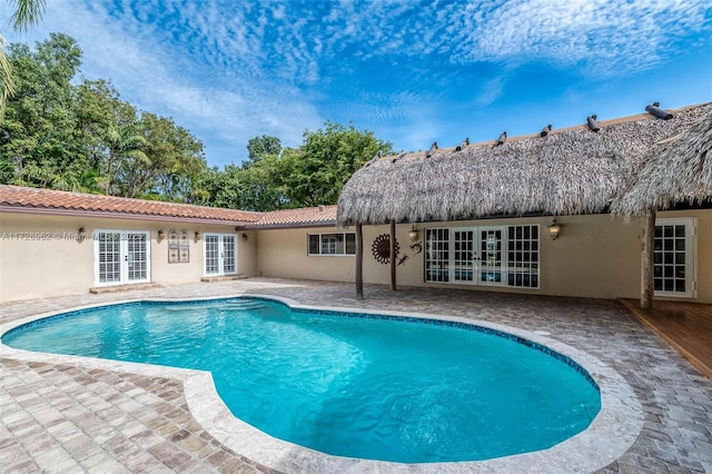 view of pool with a patio area and french doors