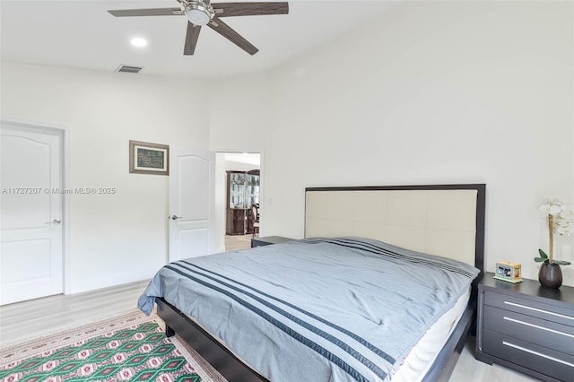 bedroom featuring lofted ceiling, ceiling fan, and light hardwood / wood-style flooring