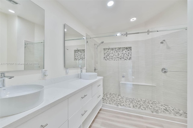 bathroom featuring vanity and an enclosed shower