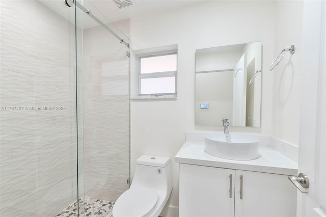 bathroom featuring vanity, toilet, and an enclosed shower