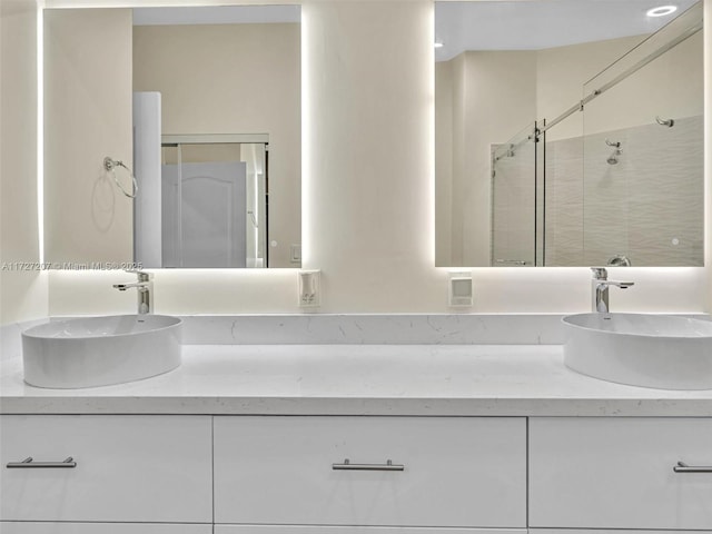 bathroom with walk in shower and vanity