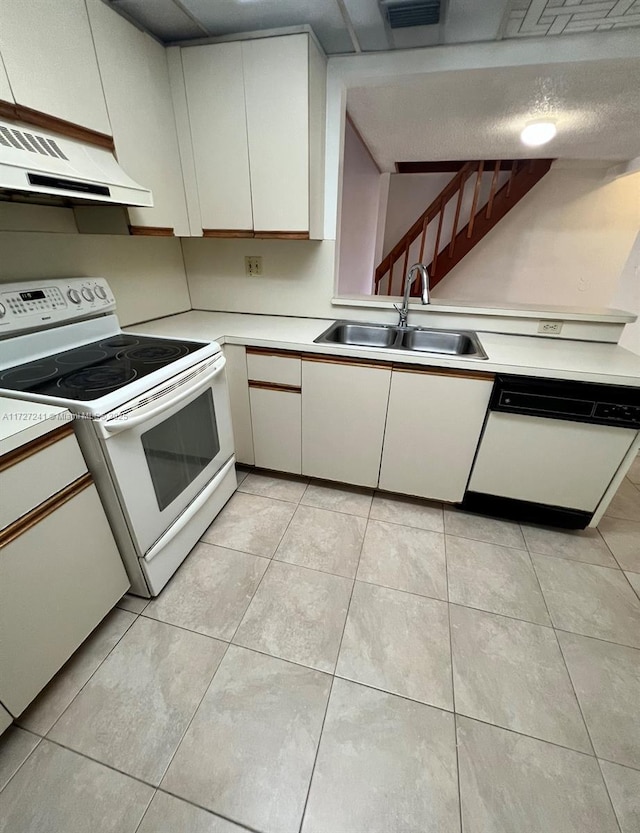 kitchen with extractor fan, white appliances, light tile patterned flooring, white cabinets, and sink