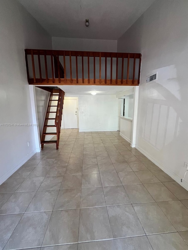 stairway featuring tile patterned floors