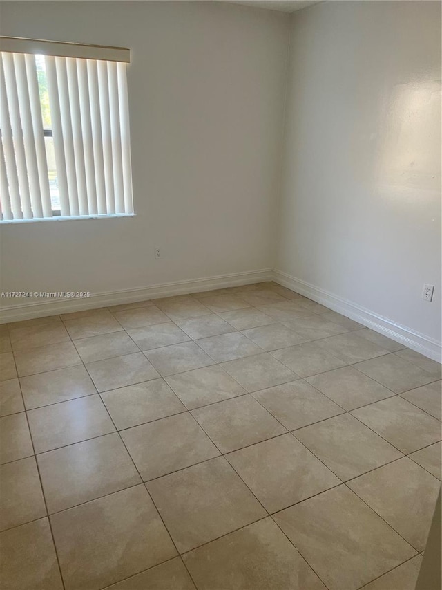 unfurnished room with light tile patterned floors