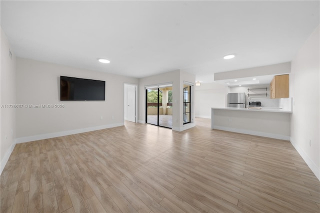 unfurnished living room with light hardwood / wood-style flooring