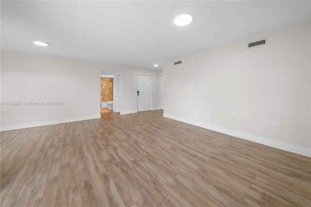 empty room with light hardwood / wood-style flooring