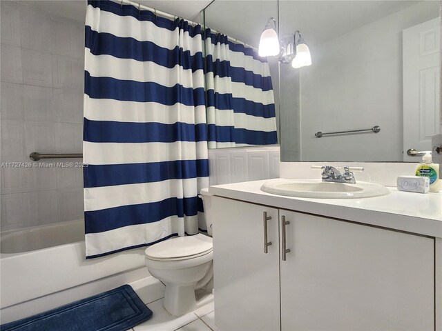 full bathroom featuring vanity, combined bath / shower with glass door, tile patterned floors, and toilet