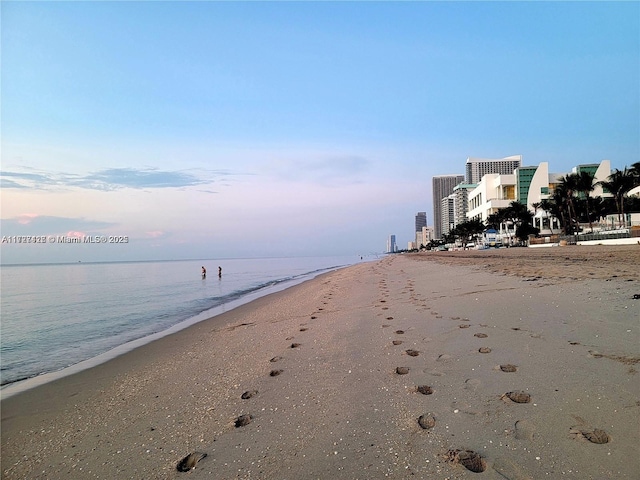 view of road featuring a view of the beach and a water view