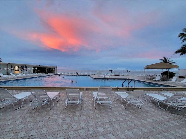 pool at dusk with a water view