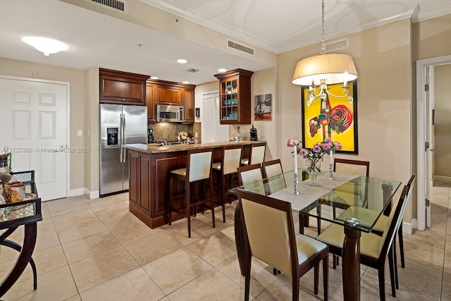 tiled dining room with ornamental molding