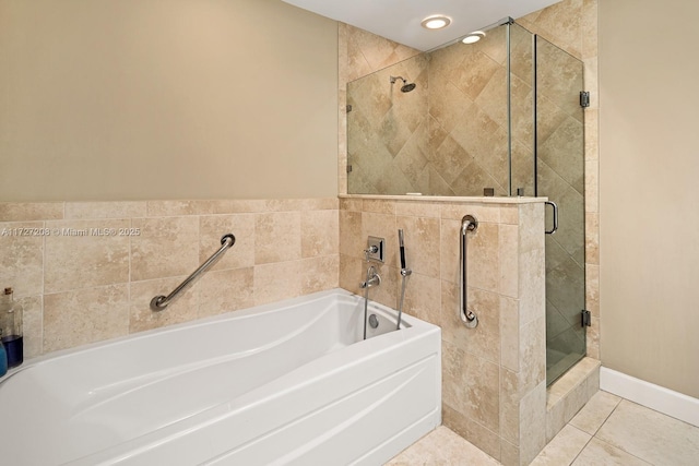 bathroom with separate shower and tub and tile patterned flooring