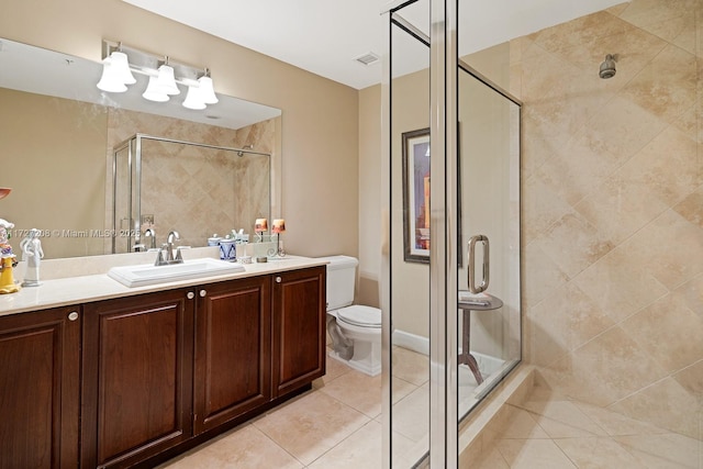 bathroom with tile patterned flooring, toilet, vanity, and walk in shower