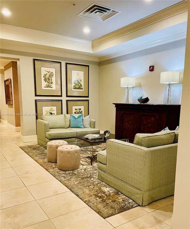 tiled living room with ornamental molding and a tray ceiling