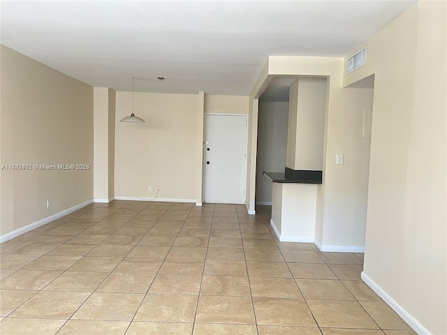 empty room with light tile patterned floors