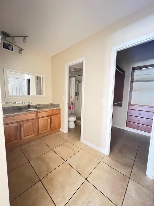 bathroom with ceiling fan, tile patterned floors, vanity, and toilet