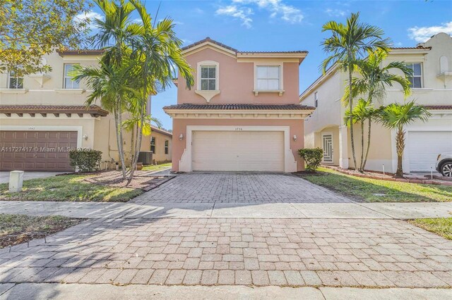 mediterranean / spanish-style house with a garage