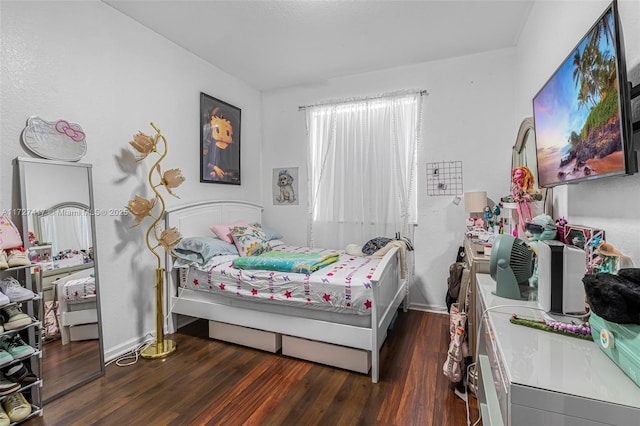 bedroom with dark hardwood / wood-style flooring