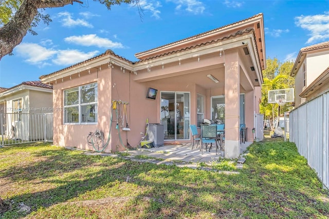 rear view of property featuring a yard and a patio