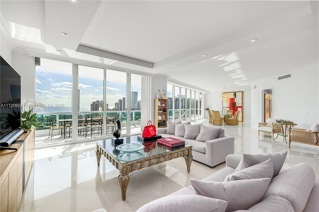 living room featuring visible vents, a city view, a tray ceiling, recessed lighting, and a wall of windows