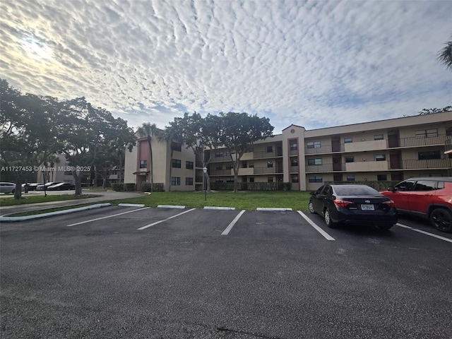 view of car parking featuring a lawn