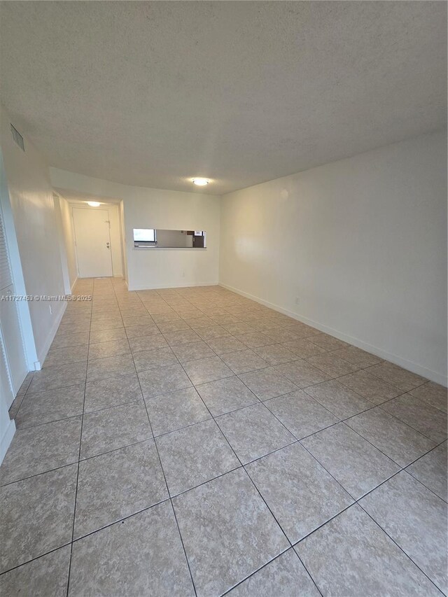 kitchen featuring light tile patterned flooring, white appliances, and tasteful backsplash