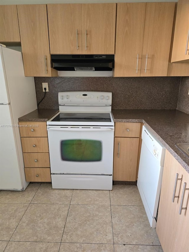 kitchen with light tile patterned floors, decorative backsplash, and white appliances