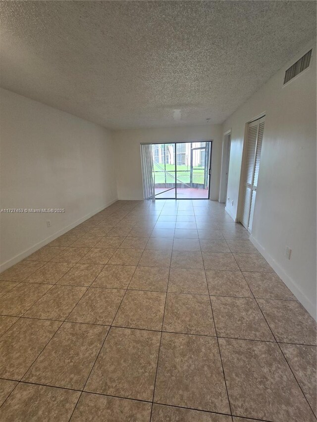 bathroom featuring tiled shower / bath and tile patterned flooring