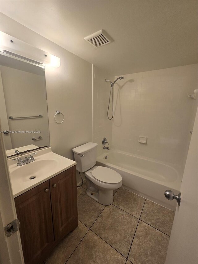 empty room with a textured ceiling and light tile patterned floors