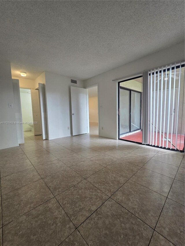 walk in closet with electric panel and tile patterned flooring