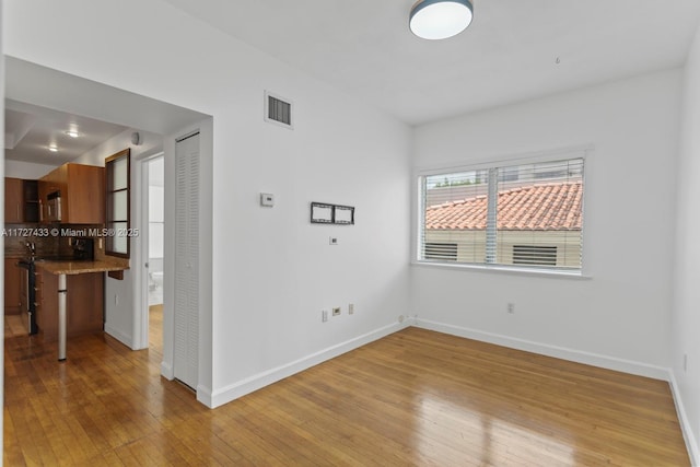 unfurnished room with light wood-type flooring