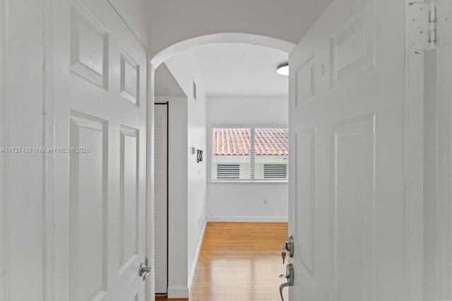 corridor with light hardwood / wood-style floors