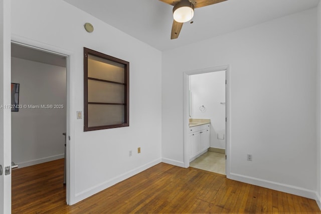 unfurnished bedroom with hardwood / wood-style flooring, ceiling fan, and ensuite bathroom